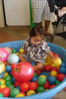 girl playing in the ball pit